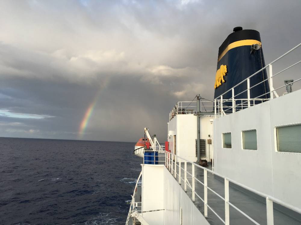 Training Ship Golden Bear with rainbow in distance