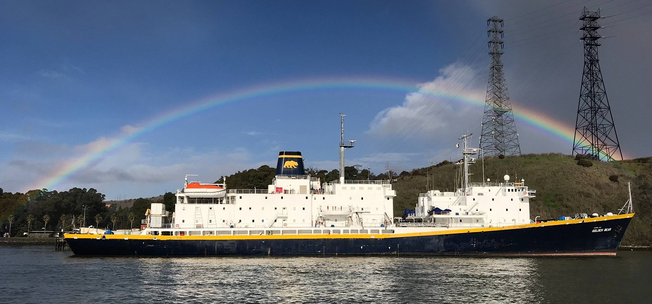 training ship with a rainbow in the background